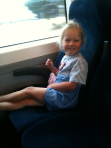 Allegra in an upcycled doona cover dress on the train on our way to the city.